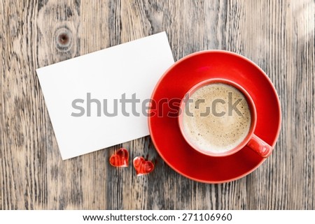 Card. Blank valentines greeting card and red coffee cup on wooden background