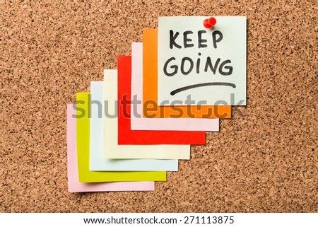 Concept. Keep going - motivation or determination concept - handwriting on colorful sticky notes