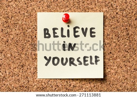 Achieve. Believe In Yourself, written on an yellow sticky note on a cork bulletin board