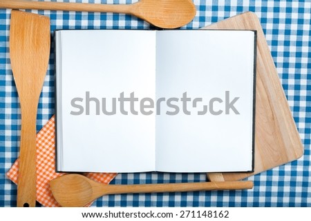 Book. Double page spread blank ring binder with copy space. Great recipes backdrop on a green gingham table top with kitchen equipment surround.