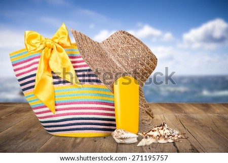 Stuff. Beach accessories on the sand near sea, skin protection, seashell, hat, bag, day spa, tropical resort, luxury lifestyle,  summertime vacation