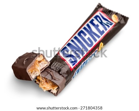 KHERSON, UKRAINE - NOVEMBER 05, 2014: Background. Snickers chocolate bar made by Mars, Incorporated. It consists of caramel and peanuts, Snickers is the best selling brand chocolate bars in the world