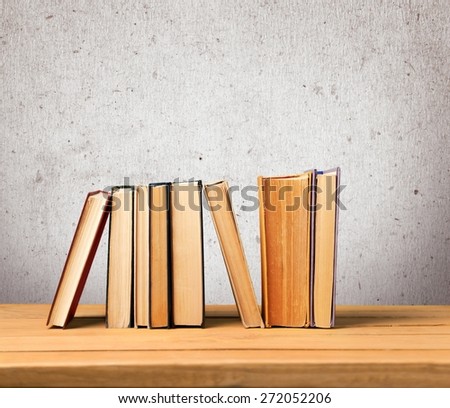 Book. Vintage books on wooden table over retro wallpaper background