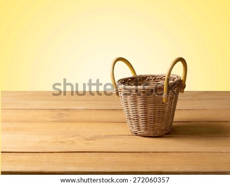 Tablecloth. Background with wooden deck tabletop and empty basket against grunge wall