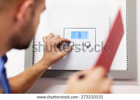 Boiler. Technician servicing the gas boiler for hot water and heating