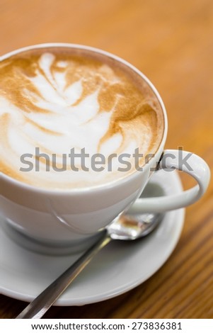 Coffee. Cappuccino cup with drawing on scum