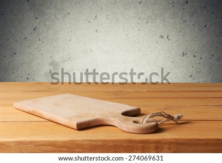 Board. Background with cutting board on wooden table over vintage wallpaper