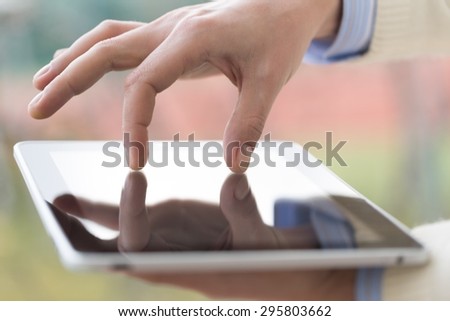 Tablet, finger, internet.