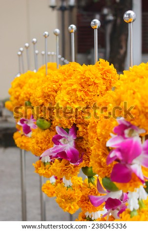 Marigolds garlands on temple fence