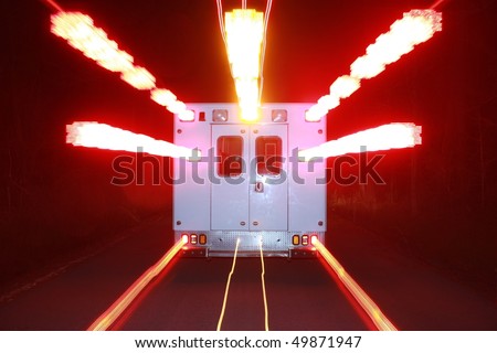 an ambulance speeds toward an emergency with its warning lights flashing
