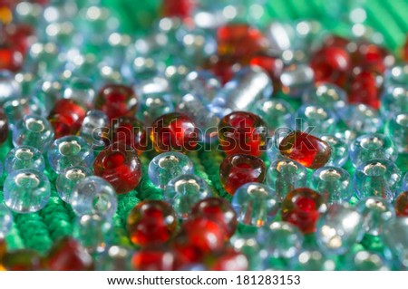 The scattered beads of red and gray color close up