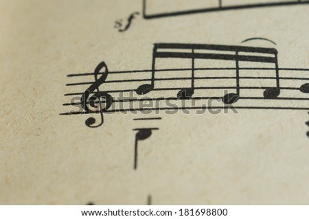 Treble clef and some notes close up on the page