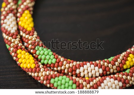 Knitted necklace from beads with a geometrical pattern