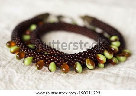 Necklace from beads of different types on a textile background