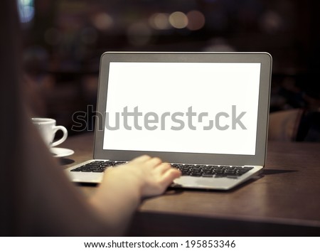 Laptop on table with hand