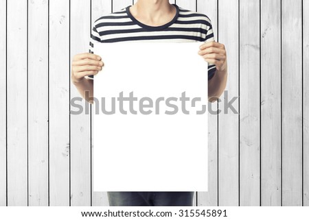 Young man holding paper