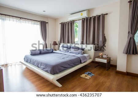 Big comfortable double bed in modern bedroom