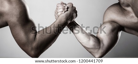 Muscular hand. Arm wrestling. Two men arm wrestling. Rivalry, closeup of male arm wrestling. Two hands. Men measuring forces, arms. Hand wrestling, compete. Hands or arms of man. Black and white.