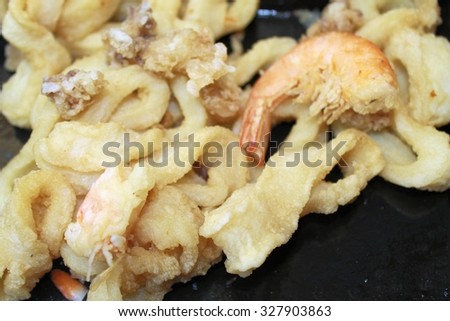 mixture of fried fish with rings of squid and shrimp