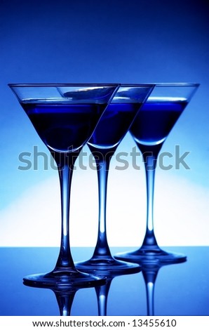 Three blue cocktails on blue background
