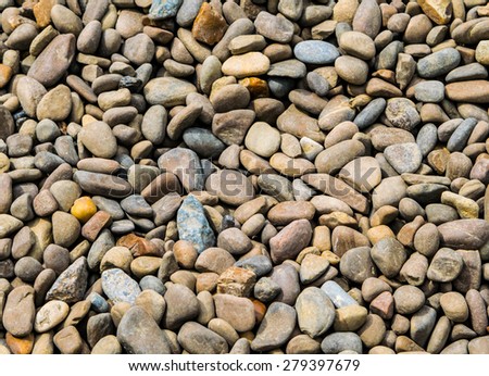 Gray and colorfull river pebbles as a background