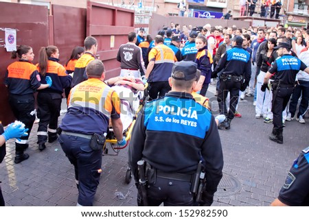 MADRID SUBURB OF SAN SEBASTIAN DE LOS REYES -SEPT. 29, 2013: A wounded man carried away on a stretcher in San Sebastian de los Reyes during festival, Spain in 2013. Fiesta called \