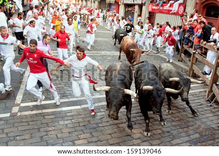 Pamplona, Spain -July 14: Unidentified Men Run From Bulls In Street Estafeta During San Fermin Festival In Pamplona, Spain On July 14, 2013.