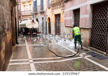 PAMPLONA, SPAIN-JULY 14: Cleaning street after closing festival of San Fermin in Pamplona, Spain July 14, 2013.