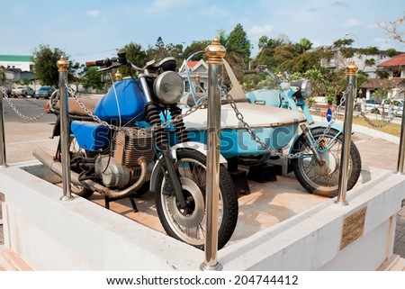 VIENTIANE, LAOS - FEBRUARY 19: Civilian and military vehicles supplied by  Soviet Union in form of aid about National History Museum, Vientiane, Laos, February 19, 2014. Motorcycle brand \
