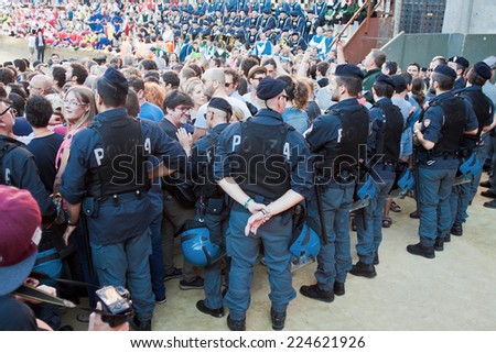SIENA, ITALY - AUGUST 16: Police keep order before start of annual traditional Palio di Siena horse race in medieval square \