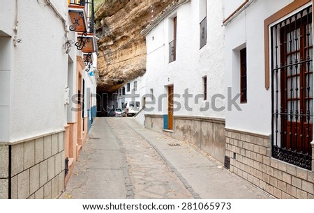 Street with dwellings built into rock overhangs above Rio Trejo. Setenil de las Bodegas, Spain