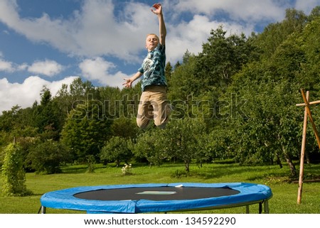 Teenage Boy Jumping on Trampoline