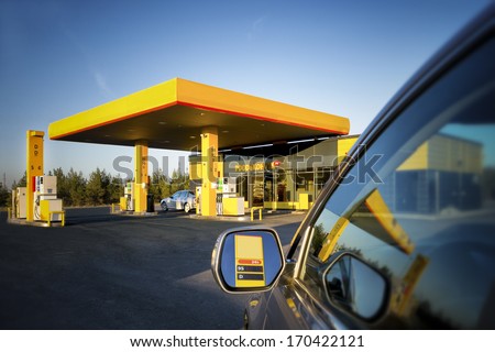 Car In Gas Station. Reflection On Motor Vehicle Mirror And Glass. Convenience Store In Estonia