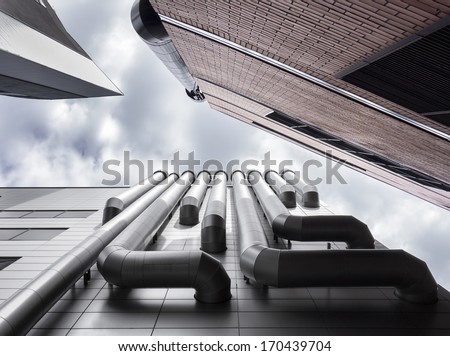 Low Angle View Of Three Skyscrapers Ventilation Pipes. Brick Wall, Venting Pipeline Or Air Duct. Tallinn, Estonia