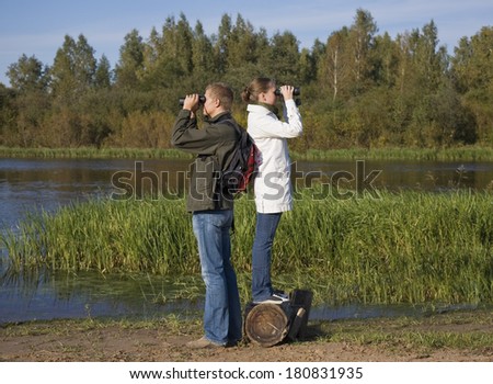 Young Couple Bird Watching. Hiking, binoculars.