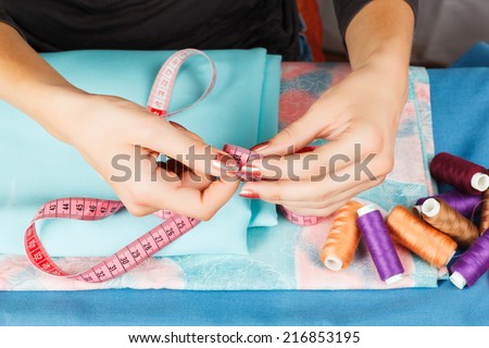 hands of a seamstress at work