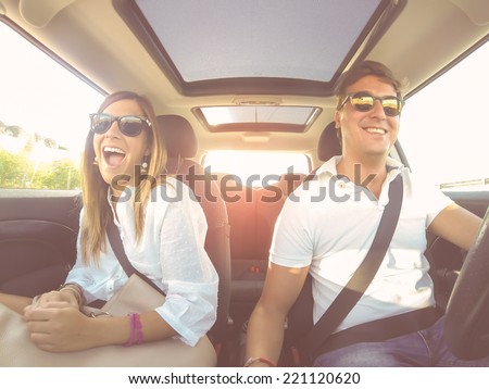 Filtered image of a couple driving at sunset during Summer