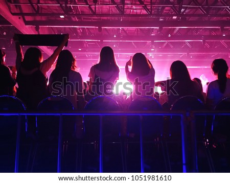 K-Pop music theme or live concert background silhouette of girls holding hands and sign for artist supporting. (space for text)
