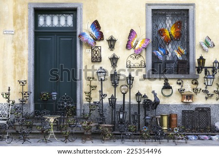 CANNOBIO, ITALY/VCO - MAY 10: exhibition of works of art in wrought iron in a shop for tourists. Hanging on the wall, several objects in a variety of shapes and colors. Cannobio, Italy - May 10, 2014