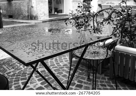Bar table under the rain. Black and white image