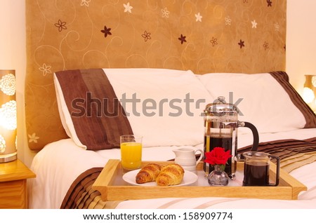 Breakfast on Bed A tray of breakfast items on a bed