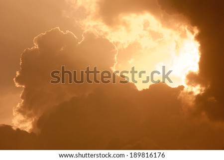 Dark orange cloudy sky at sunrise
