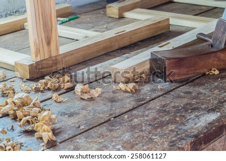 wooden plane in a workshop of the carpenter with curls of wood shavings