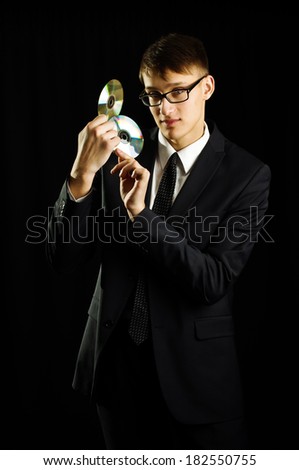 Young man holding two CD