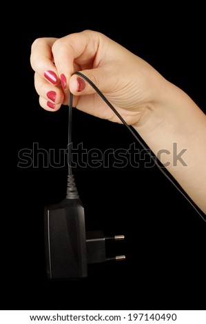 Woman hand hold black cell phone charger
