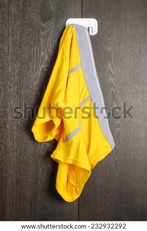 Messy yellow man underwear hanged on the wall