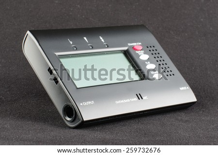 Digital guitar tuner isolated on the black background