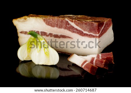 Smoked pork fat or salo on the black reflective surface