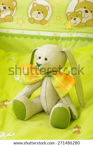 Original plush animal toy in the baby bed