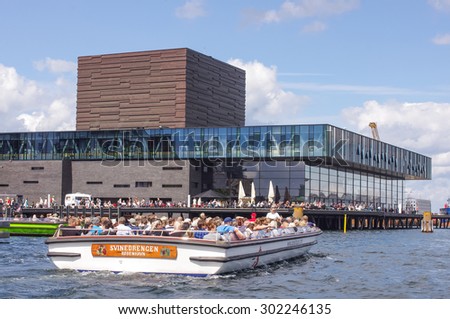 COPENHAGEN, DENMARK - JULY 21, 2015: Hop on - hop off tourist tour by boat in the Copenhagen canals, Denmark. Photo taken on July 21th 2015.